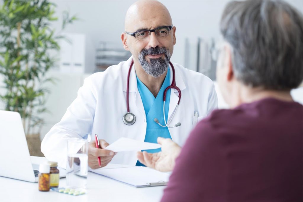 Male patient talking to doctor